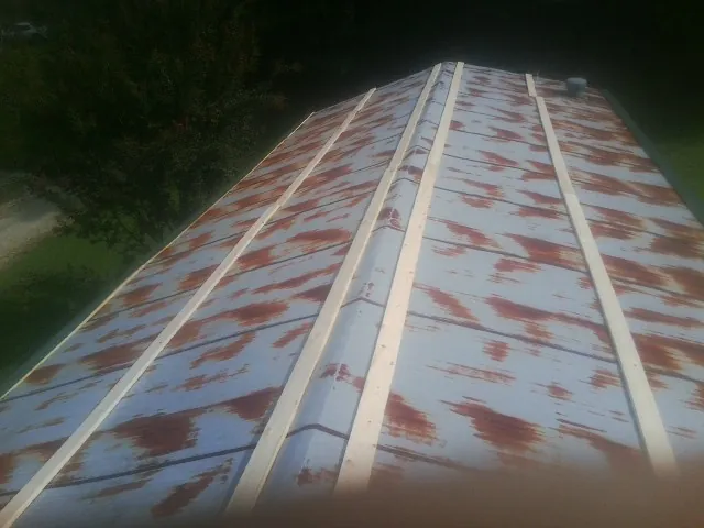 Rusted metal roof panels with new wood purlins before replacement — Storm Damage Roof Repair in Culleoka by Roofing Brothers