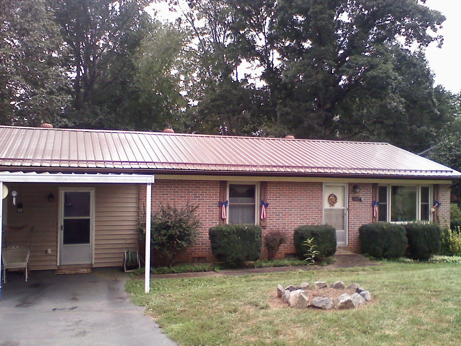 Bronze metal roof and carport on a brick ranch home — Roof Repair work by our crew in Culleoka