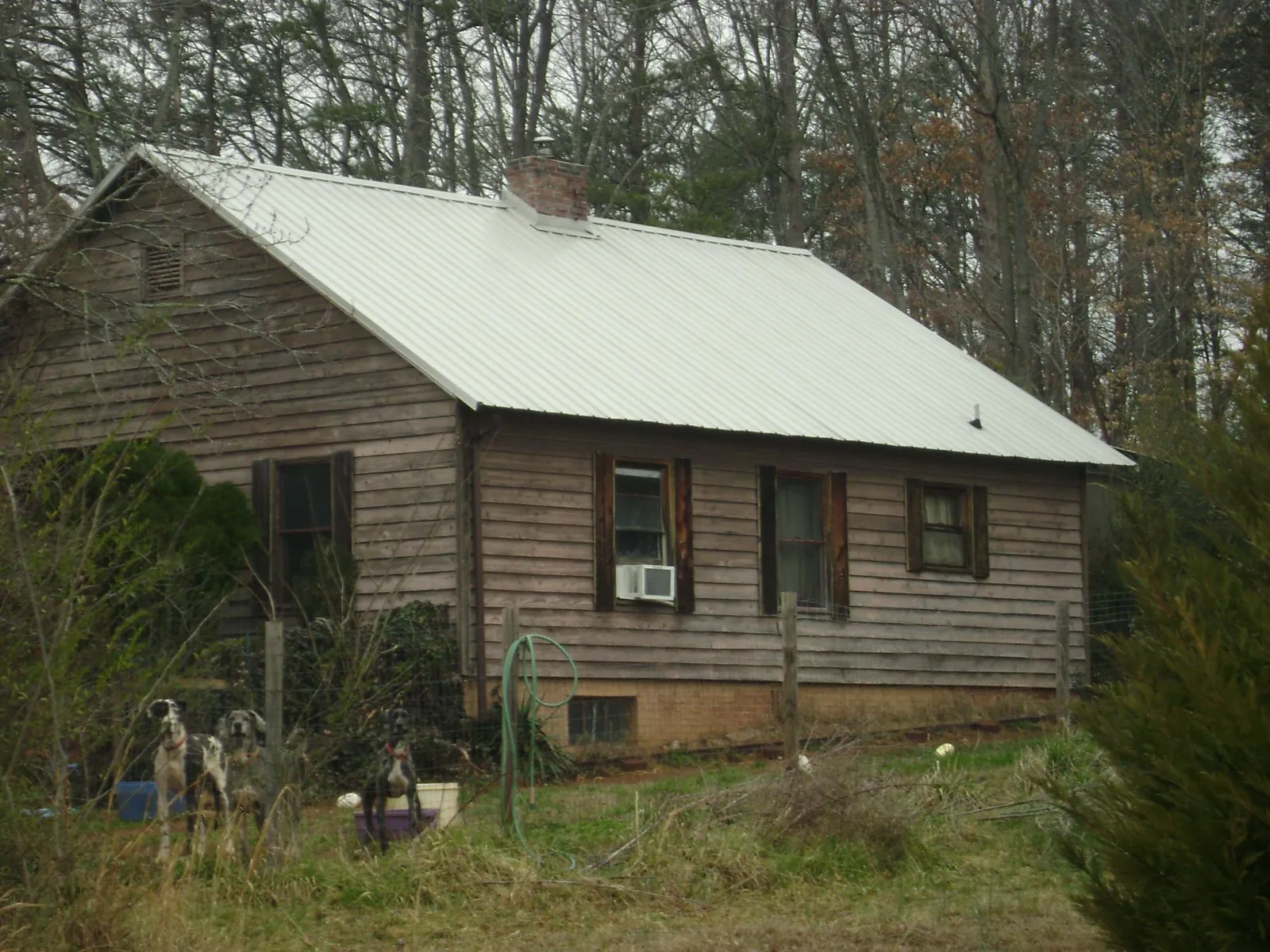 White metal roof on an old wood sided farmhouse, from a Asphalt Shingle Roof Repair job in Culleoka